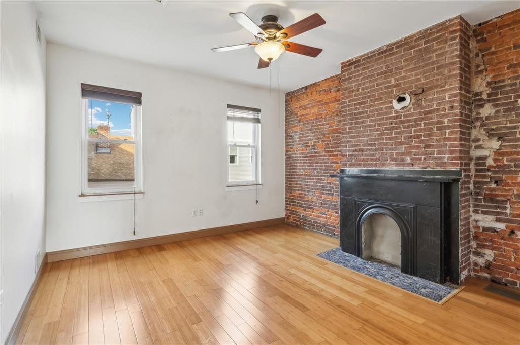 176 Lodi Way Pittsburgh, PA 15201 - Photo 19 of 28 a view of empty room with fireplace and wooden floor