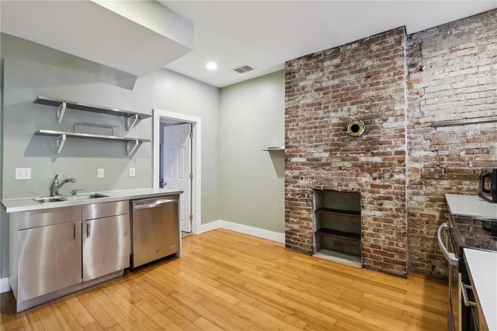 176 Lodi Way Pittsburgh, PA 15201 - Photo 8 of 28 a kitchen with stainless steel appliances wooden cabinets and a fireplace