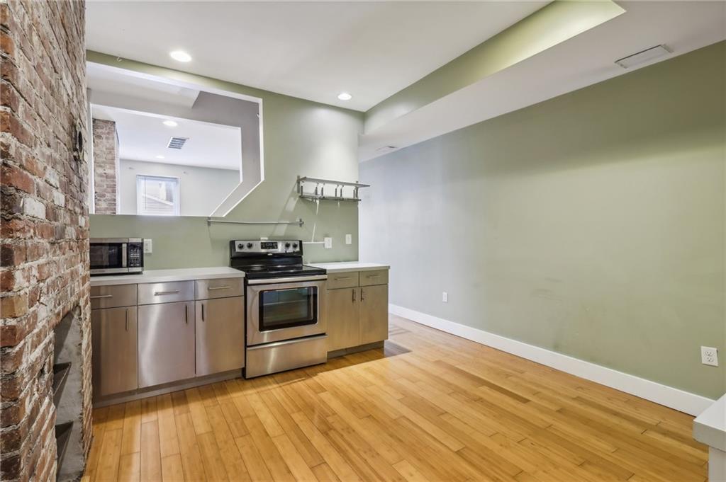 176 Lodi Way Pittsburgh, PA 15201 - Photo 10 of 28 a kitchen with a stove cabinets and a wooden floor