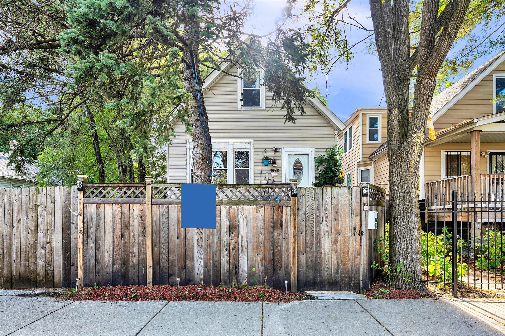 a front view of a house with a tree