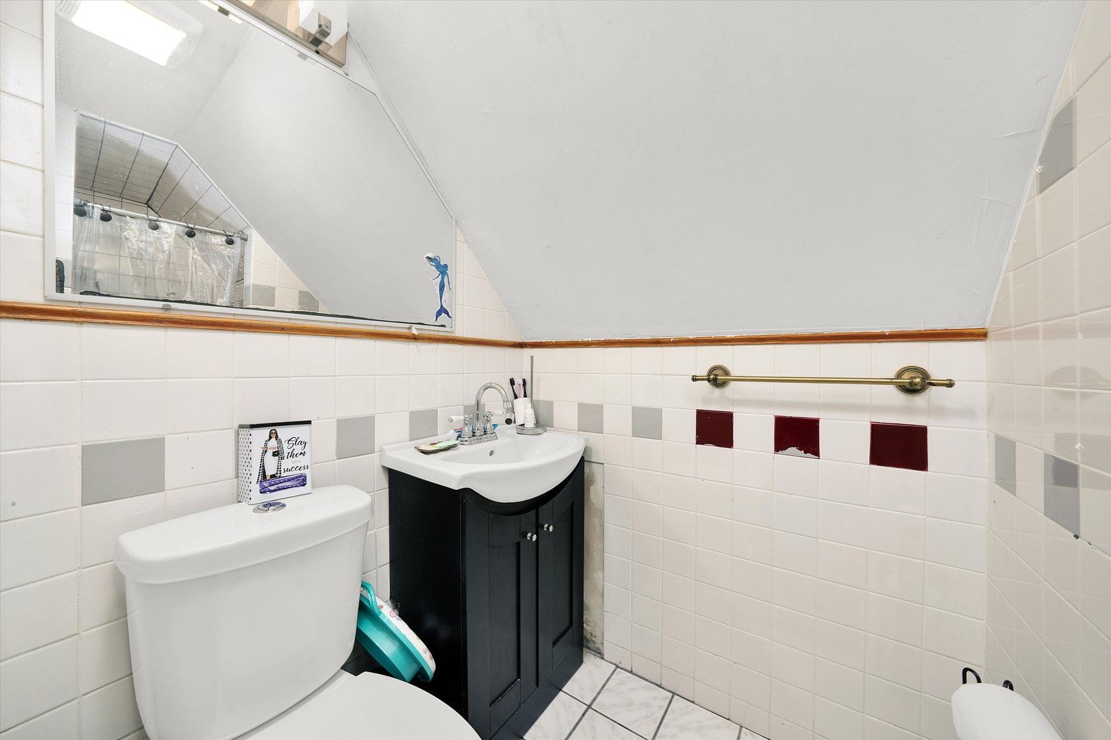331 West 107th Street Chicago, IL 60628 - Photo 16 of 28 a bathroom with a sink a toilet and a mirror