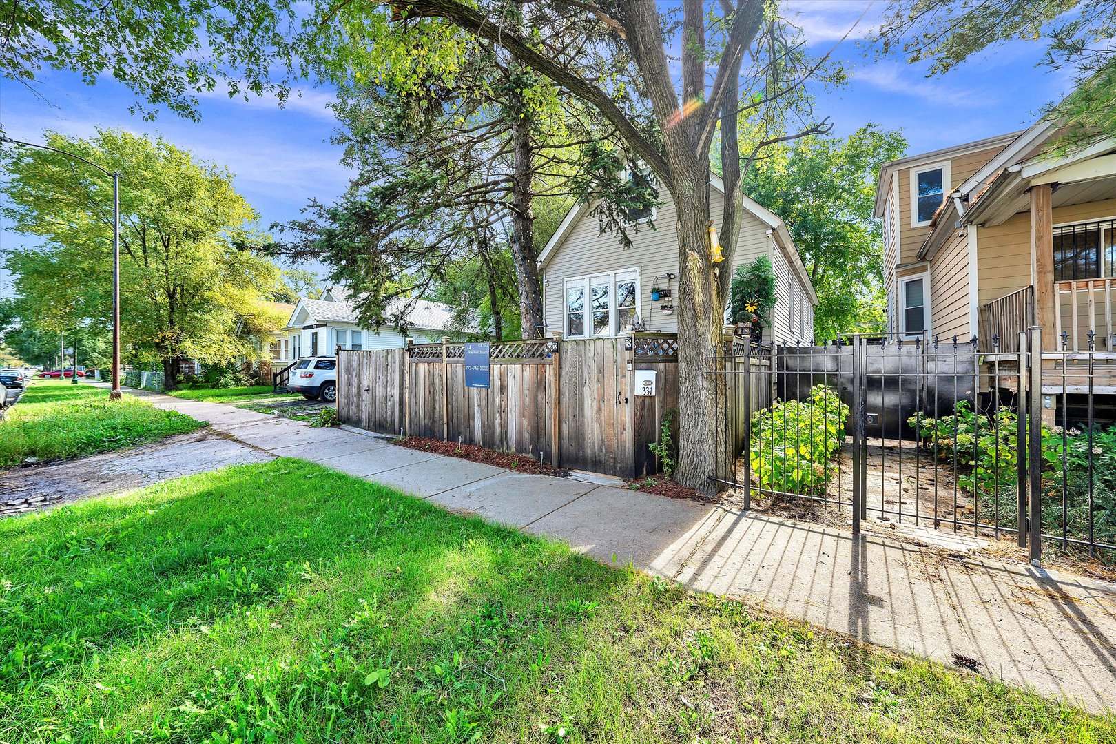 331 West 107th Street Chicago, IL 60628 - Photo 23 of 28 a view of a backyard with table and chairs and wooden fence