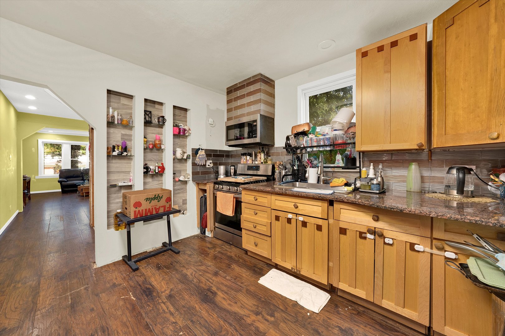 331 West 107th Street Chicago, IL 60628 - Photo 8 of 28 a kitchen with stainless steel appliances granite countertop a stove a sink and a refrigerator