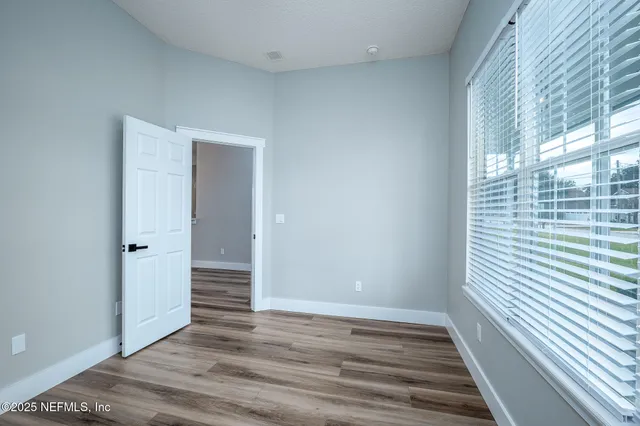 a view of a kitchen with a sink a refrigerator and window