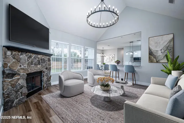 a kitchen with stainless steel appliances granite countertop a stove top oven a sink dishwasher a refrigerator and a oven with wooden floor