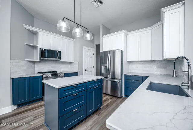 a kitchen with a refrigerator stove and microwave