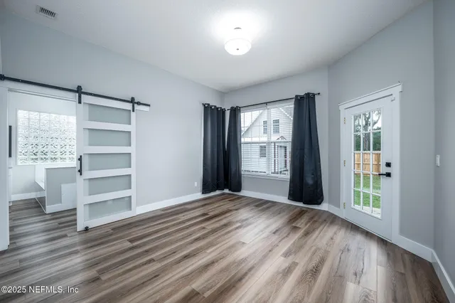 wooden floor in an empty room with a window