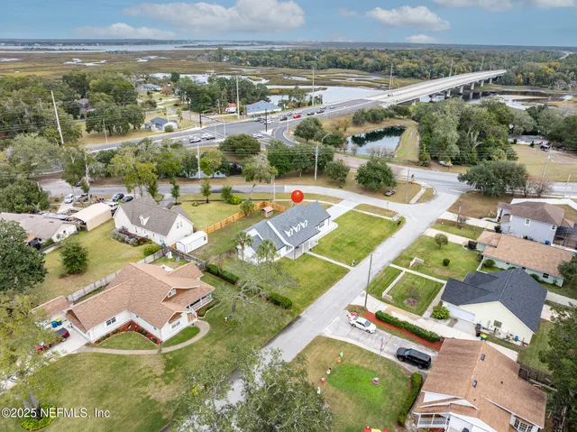 an aerial view of residential houses with outdoor space and swimming pool