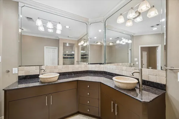 a bathroom with a granite countertop sink a large mirror and vanity