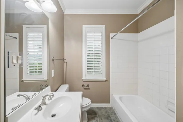 a bathroom with a tub sink and a window