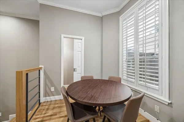 a view of a dining room with furniture and wooden floor