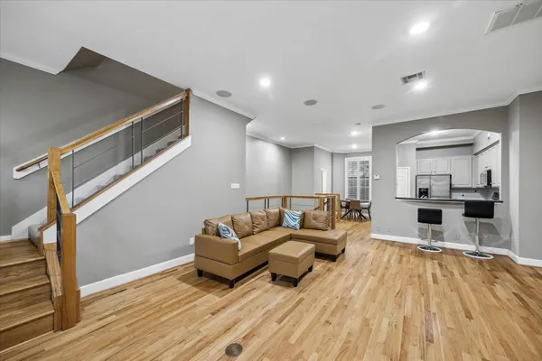 a living room with furniture and a wooden floor