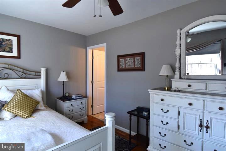 8244 Carrleigh Parkway Springfield, VA 22152 - Photo 4 of 25 a bedroom with a bed and wooden floor