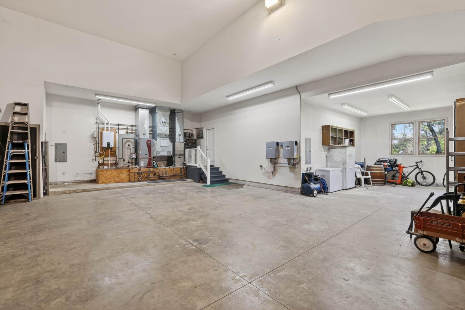 7021 Horseshoe Bar Road Loomis, CA 95650 - Photo 41 of 77 Expansive insulated attached garage with interior access, high ceilings, ample space for RV Storage, boat storage, and or a workshop or multiple vehicles.