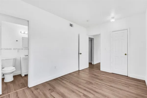 a view of an empty room and wooden floor