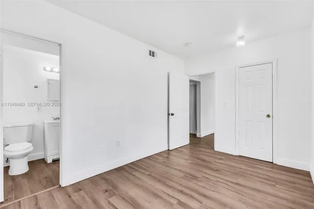 a view of an empty room and wooden floor