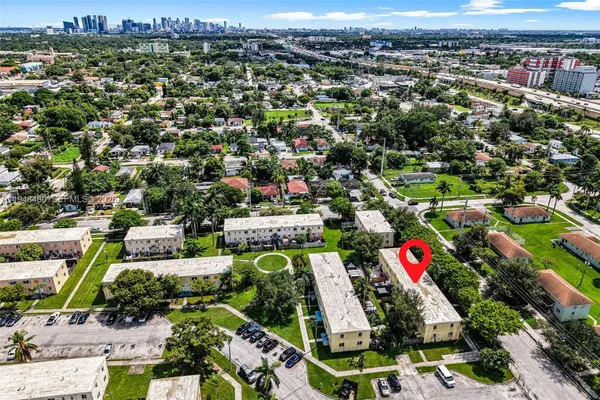 an aerial view of residential houses with outdoor space and swimming pool