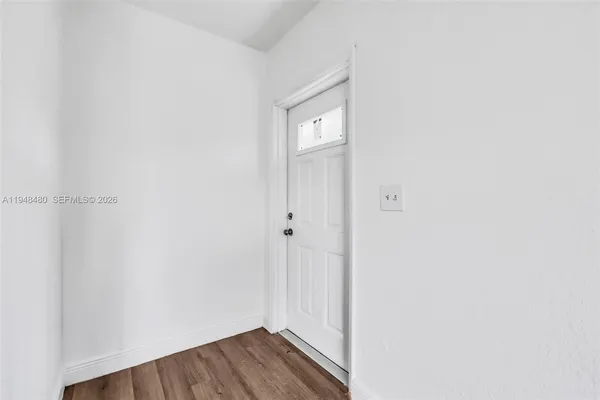 a view of a hallway with wooden floor