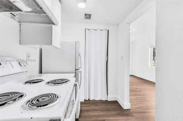 a kitchen with a refrigerator and a stove