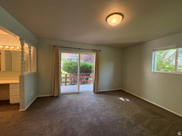 595 Meadowlark Road Orem, UT 84097 - Photo 24 of 87 Carpeted room featuring a ceiling-mounted light fixture, sliding glass doors to an outdoor deck, and a single-pane window