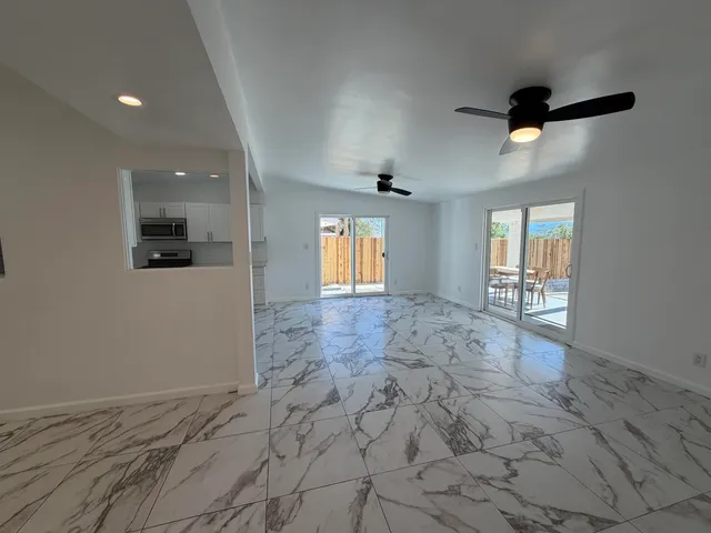 a view of a kitchen with a sink and cabinets