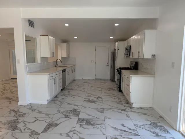 a kitchen with a sink and cabinets