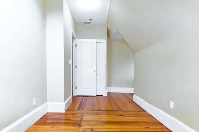 a view of a room with wooden floor and staircase