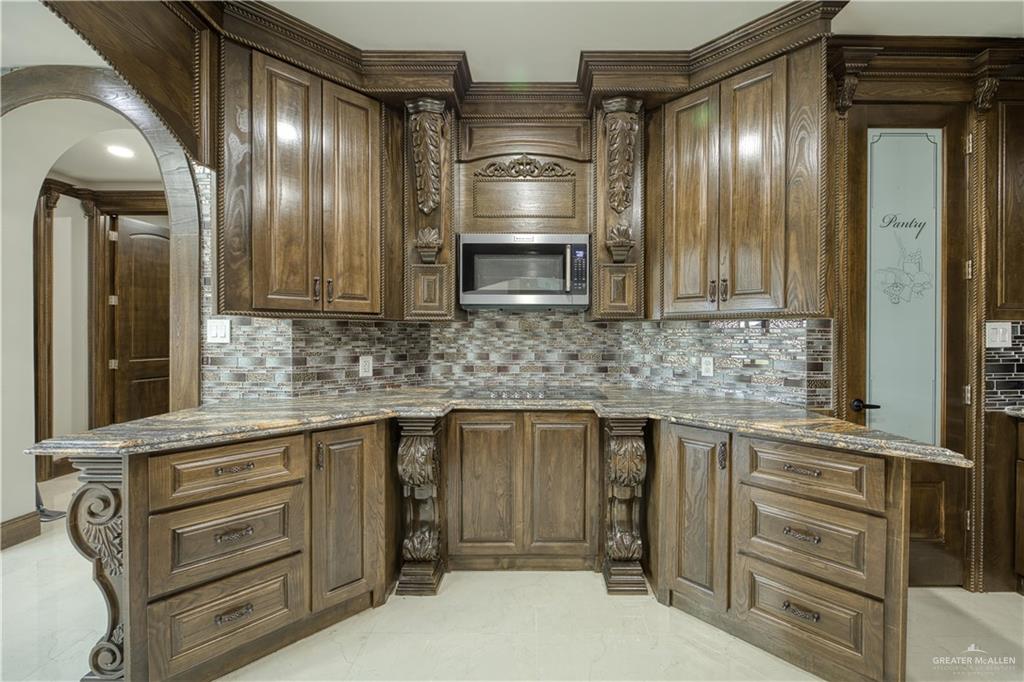 2916 Fletcher Street Weslaco, TX 78599 - Photo 13 of 45 a kitchen with cabinets and stainless steel appliances