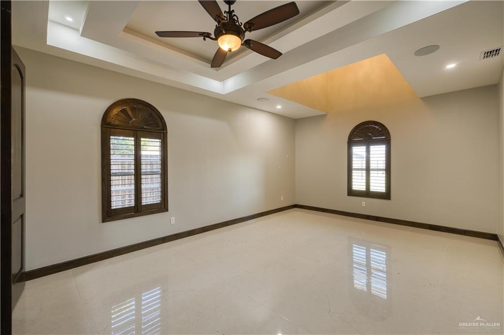 2916 Fletcher Street Weslaco, TX 78599 - Photo 16 of 45 an empty room with windows and ceiling fan