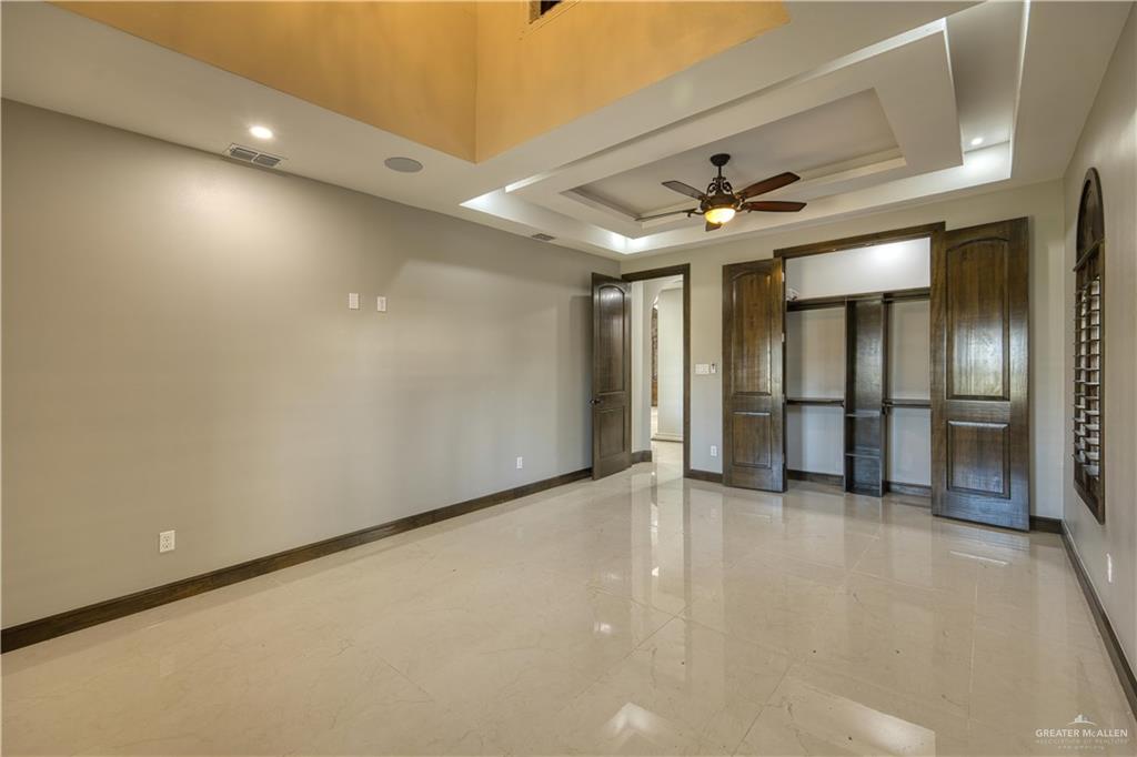 2916 Fletcher Street Weslaco, TX 78599 - Photo 17 of 45 an empty room with windows and ceiling fan