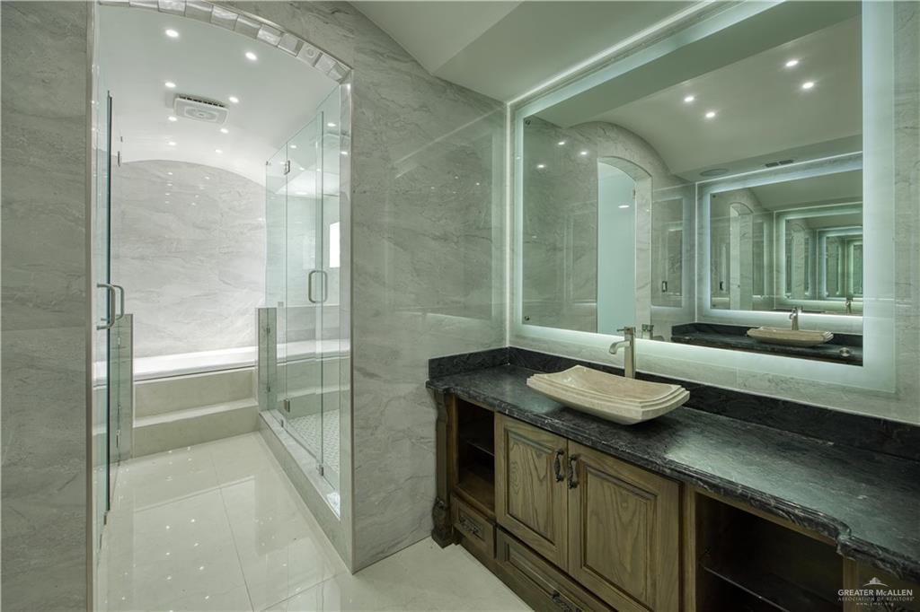 2916 Fletcher Street Weslaco, TX 78599 - Photo 24 of 45 a bathroom with a granite countertop sink mirror and double