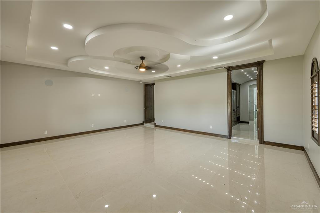 2916 Fletcher Street Weslaco, TX 78599 - Photo 42 of 45 an empty room with a ceiling fan and a projector