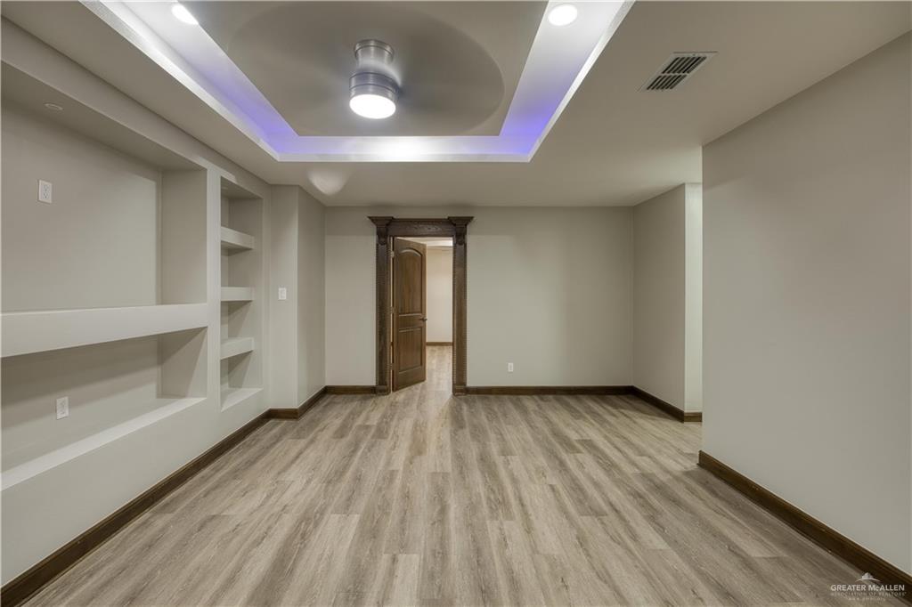 2916 Fletcher Street Weslaco, TX 78599 - Photo 43 of 45 wooden floor in an empty room with a window