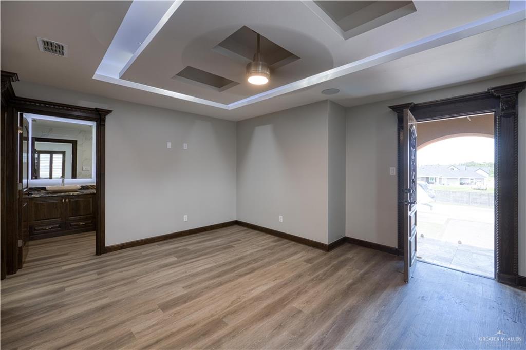 2916 Fletcher Street Weslaco, TX 78599 - Photo 44 of 45 an empty room with wooden floor and windows