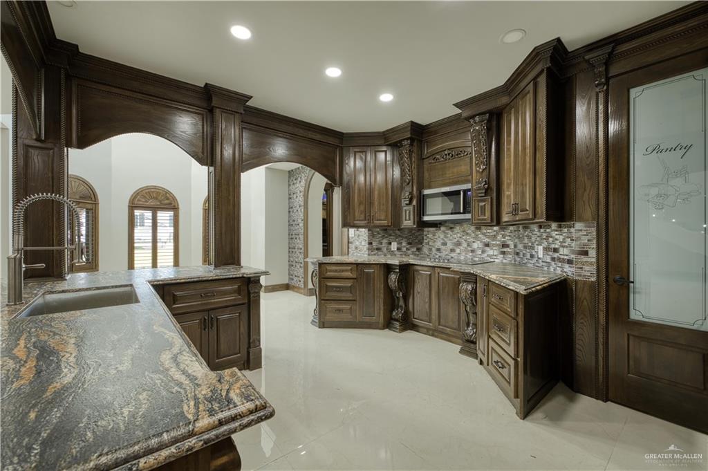 2916 Fletcher Street Weslaco, TX 78599 - Photo 9 of 45 a large kitchen with stainless steel appliances granite countertop a large counter top and a stove
