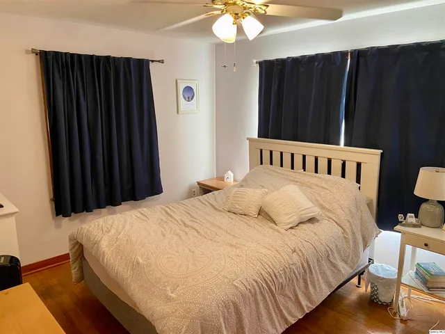 a bedroom with a bed and a mirror