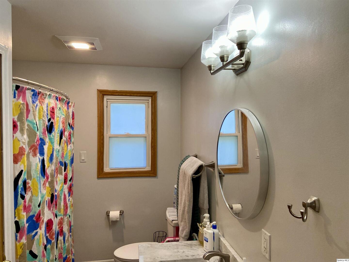 1632 North 24th Street Quincy, IL 62301 - Photo 17 of 36 a bathroom with a sink mirror and toilet