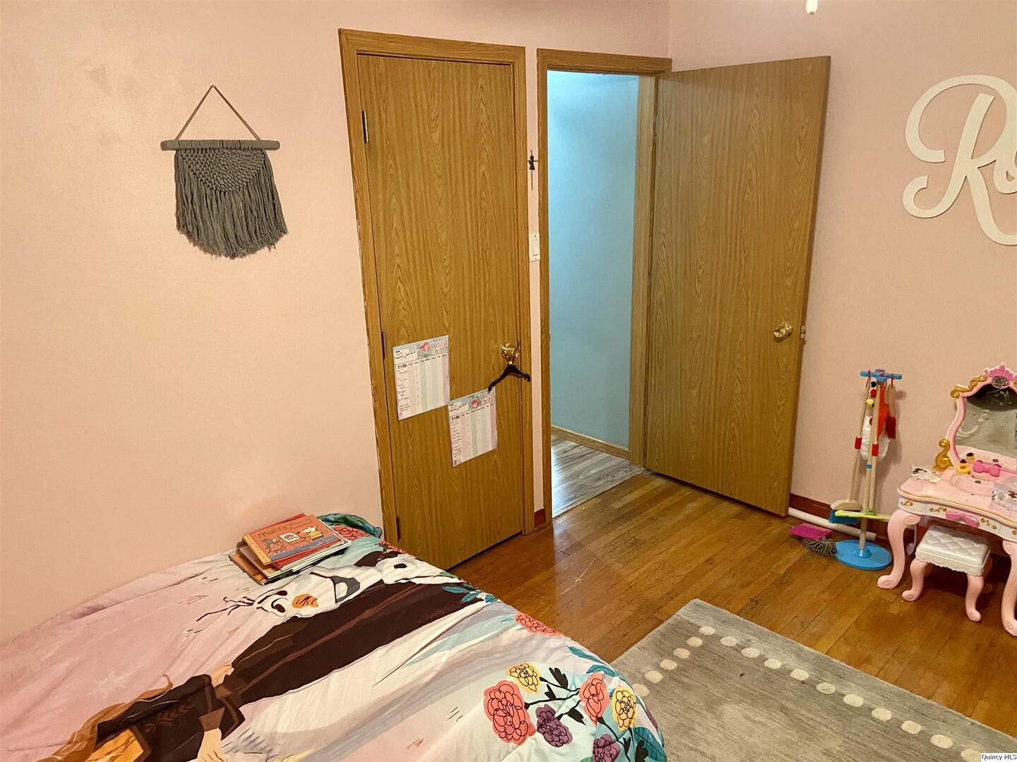 1632 North 24th Street Quincy, IL 62301 - Photo 20 of 36 a bedroom with a bed and wooden floor