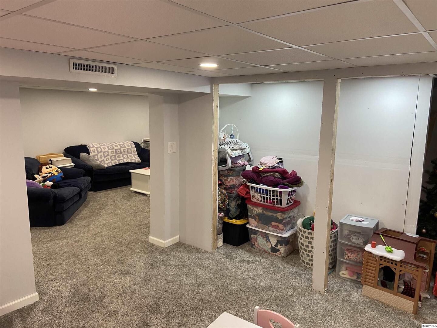 1632 North 24th Street Quincy, IL 62301 - Photo 27 of 36 a living room with furniture and a gym machine