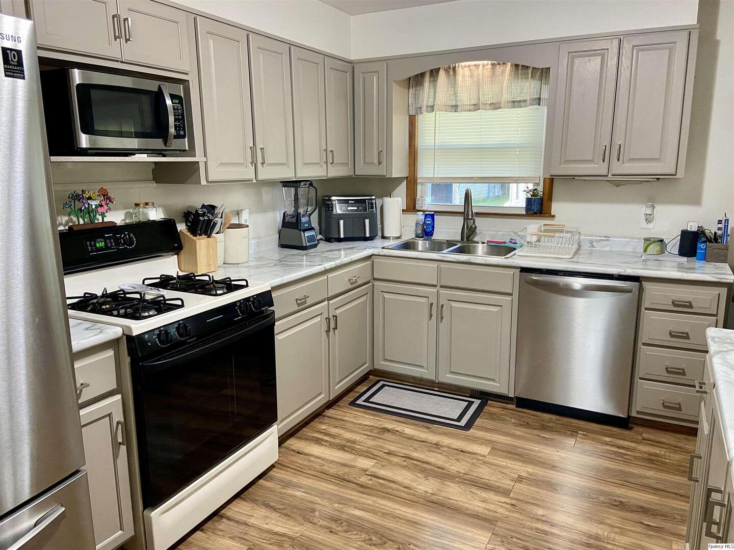 1632 North 24th Street Quincy, IL 62301 - Photo 35 of 36 a kitchen with cabinets appliances and a sink