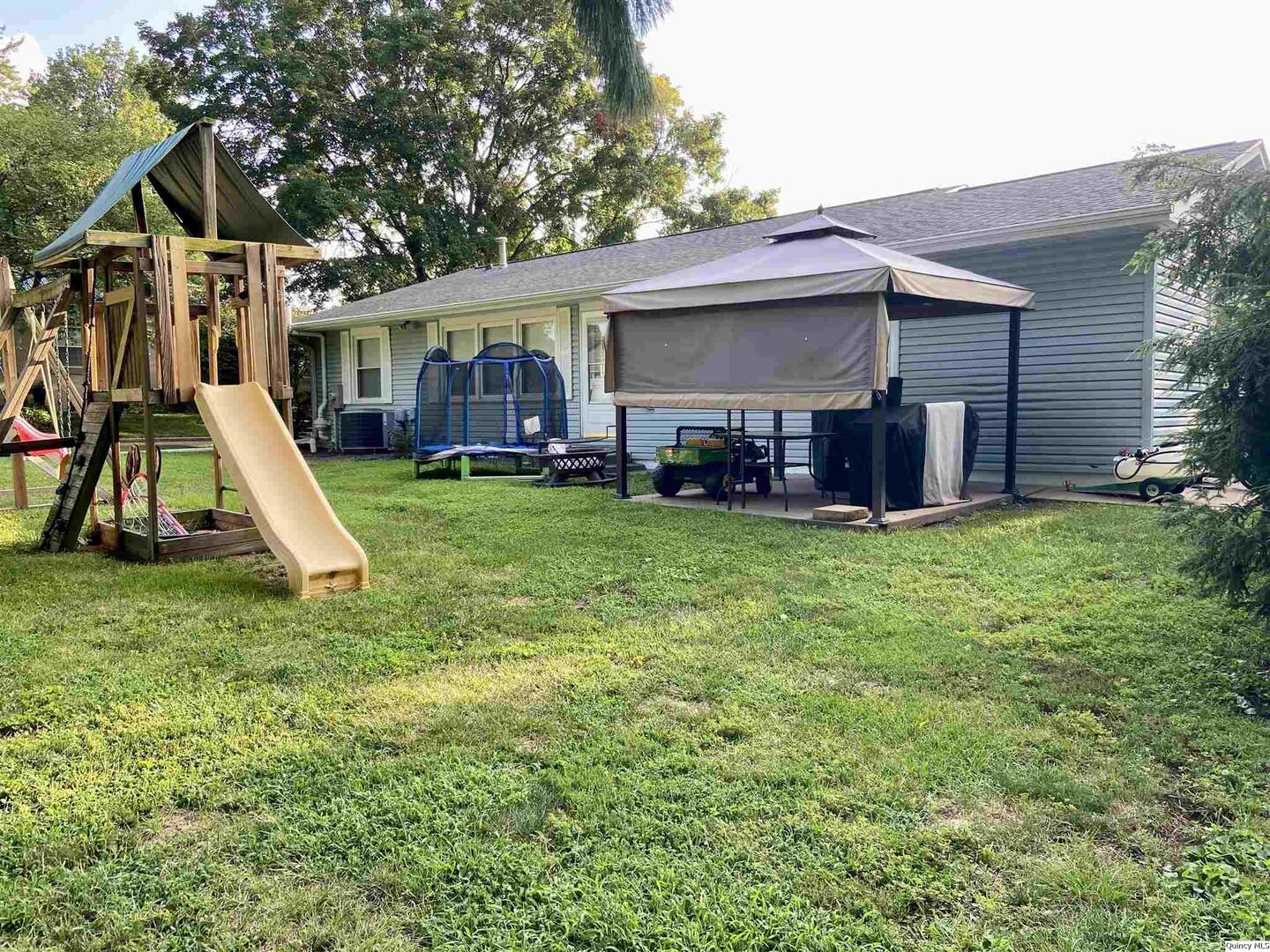 1632 North 24th Street Quincy, IL 62301 - Photo 5 of 36 a view of a house with a yard and sitting area
