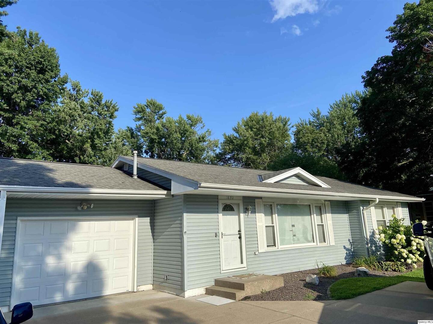 1632 North 24th Street Quincy, IL 62301 - Photo 6 of 36 a front view of a house with a yard