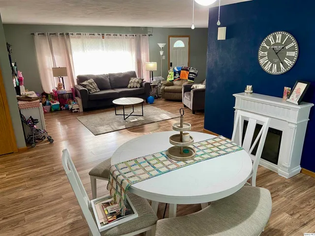 a living room with furniture a rug and a window