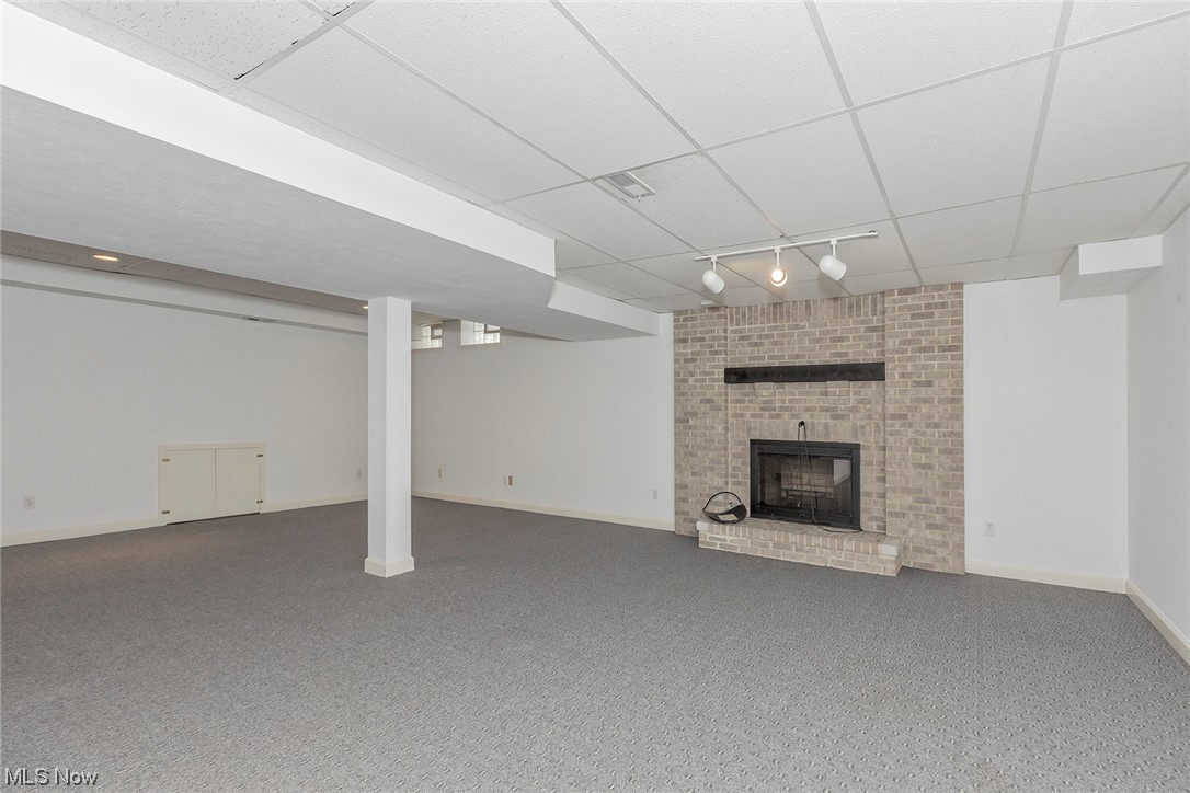 3850 Ellendale Road Moreland Hills, OH 44022 - Photo 33 of 39 Recreation Room with a paneled ceiling, a wood burning brick fireplace, and track lighting