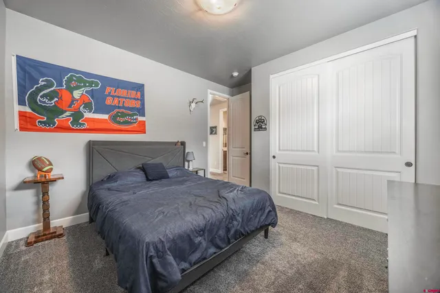 a bedroom with a bed and painting on the wall