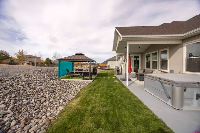 a view of house with yard and entertaining space