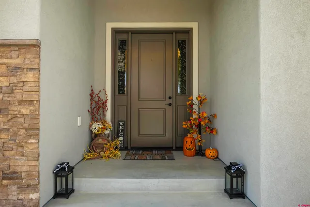 an entryway with a flower pot and a bookshelf