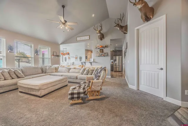 a living room with furniture and a chandelier