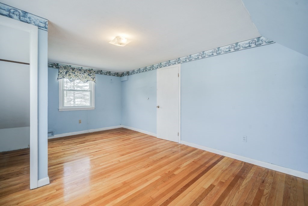 48 Fair Oak Road Springfield, MA 01128 - Photo 24 of 42 a view of an empty room with a window and wooden floor