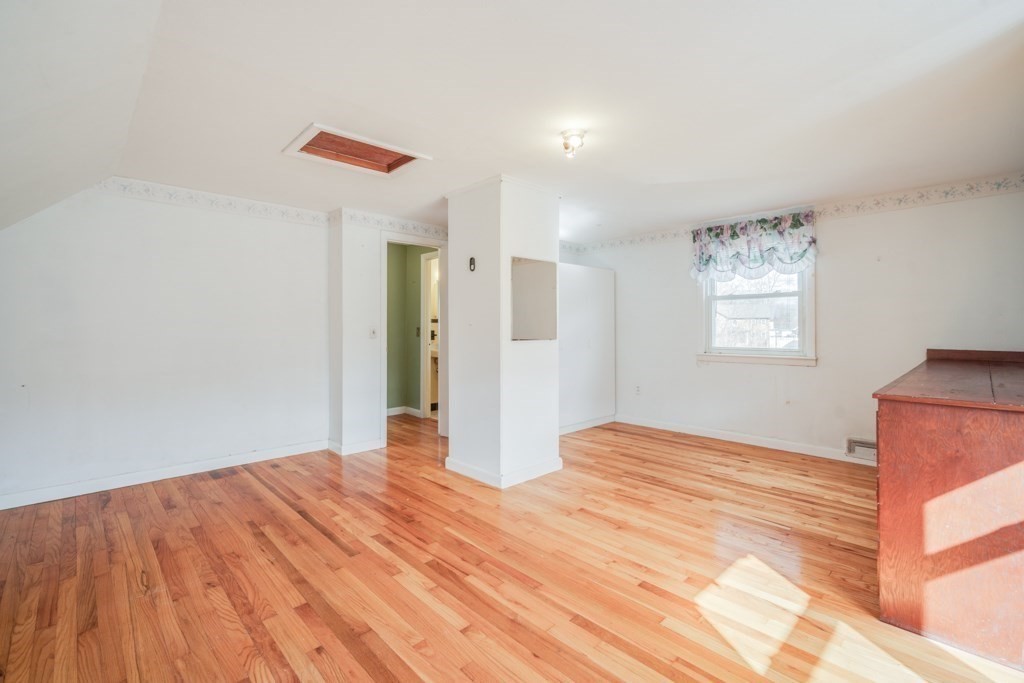48 Fair Oak Road Springfield, MA 01128 - Photo 31 of 42 a view of an empty room with wooden floor and a window